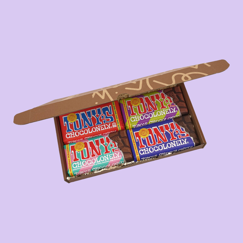 Four Bar Box open from above, four different 90g Tony's Chocolonely bars packed side by side in a brown letterbox mailer